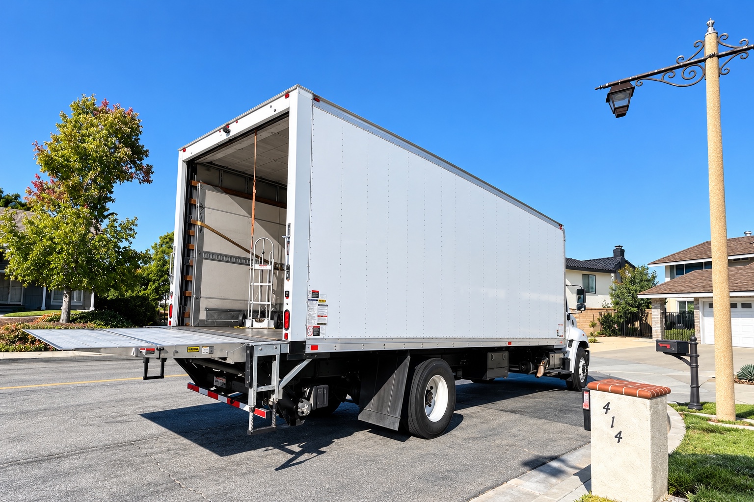 C&D box truck at a residential delivery with its liftgate open